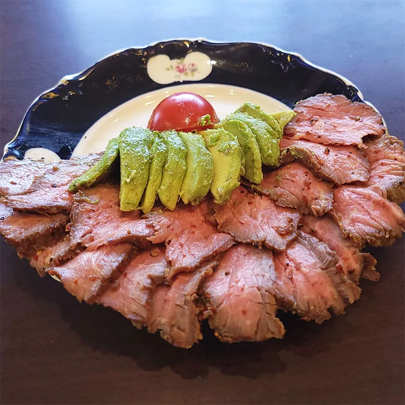 Plated tritip with avocados.