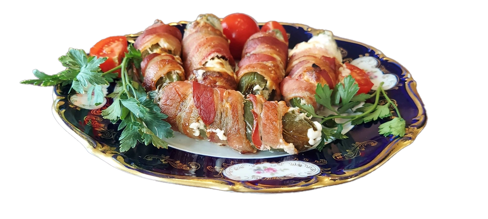 Stuffed jalapenos filled with cream cheese and wrapped with bacon.