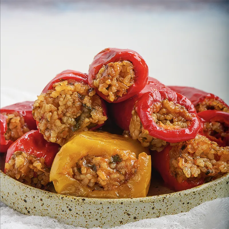 Plated rice and herb stuffed sweet pepper dolma.